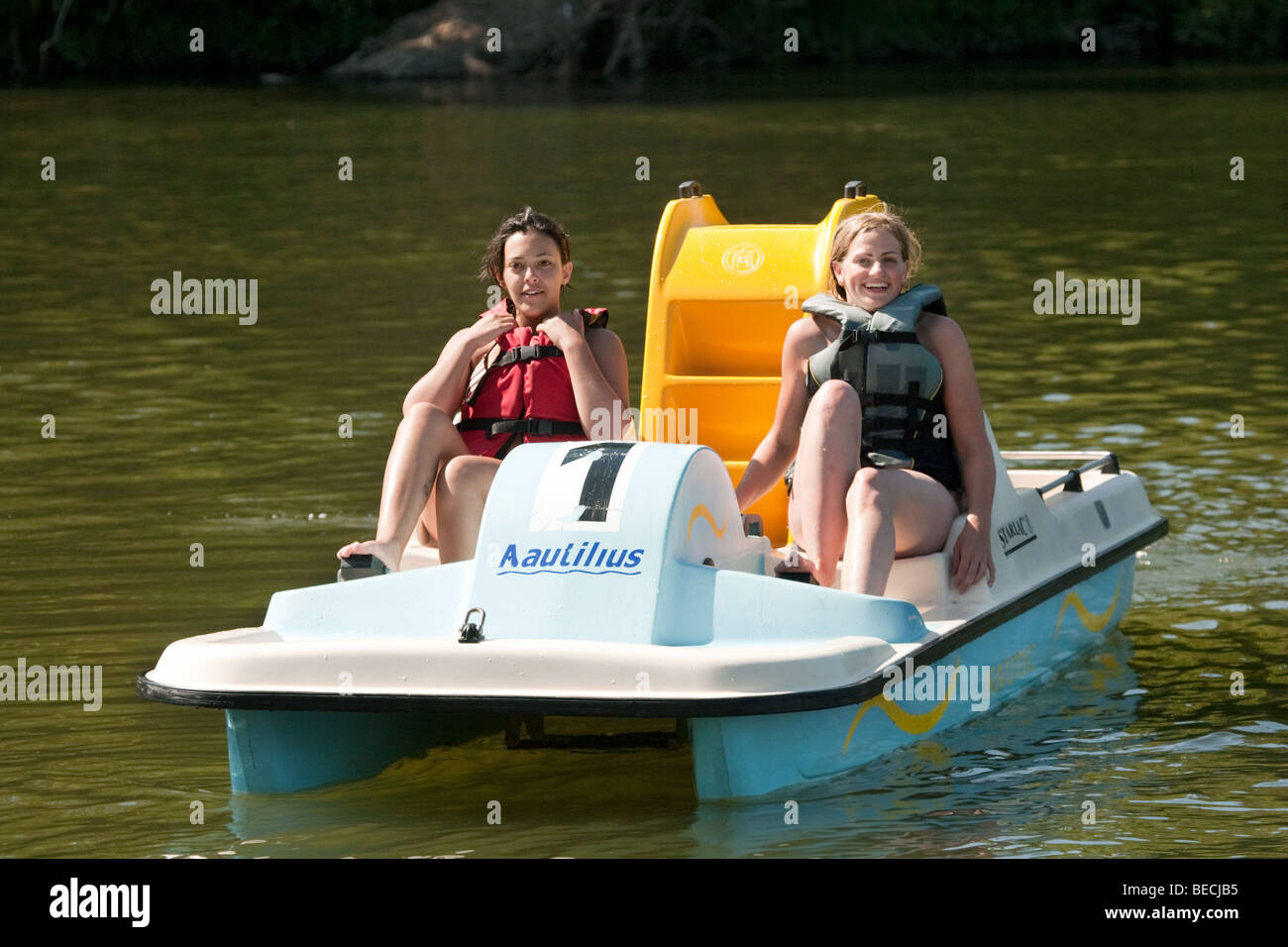 Two teenage girls having a good time in a paddle boat Stock Photo