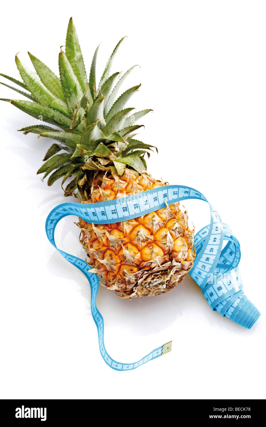 Baby pineapple with a tape measure Stock Photo