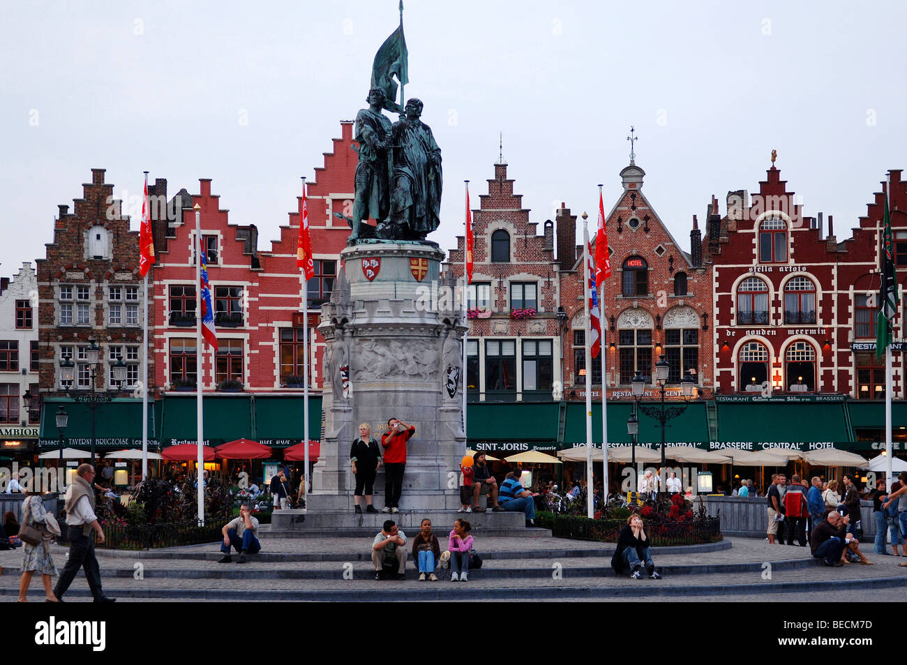 Freedom fighter monument, in the back houses with stepped gables and restaurants, Market Square, Bruges, Belgium, Europe Stock Photo