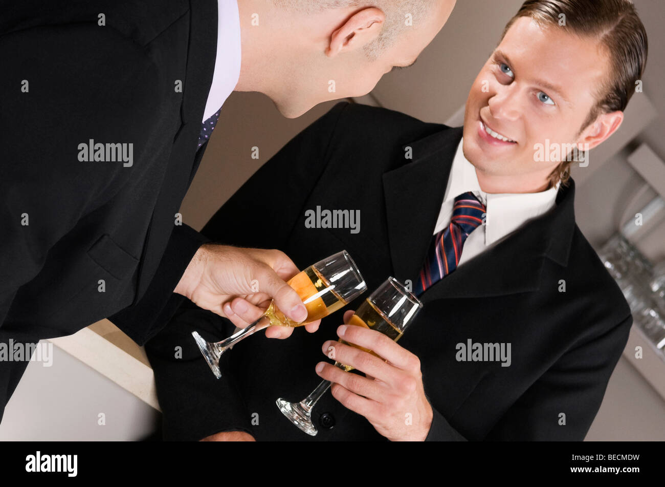 Businessmen toasting with wine in a bar Stock Photo