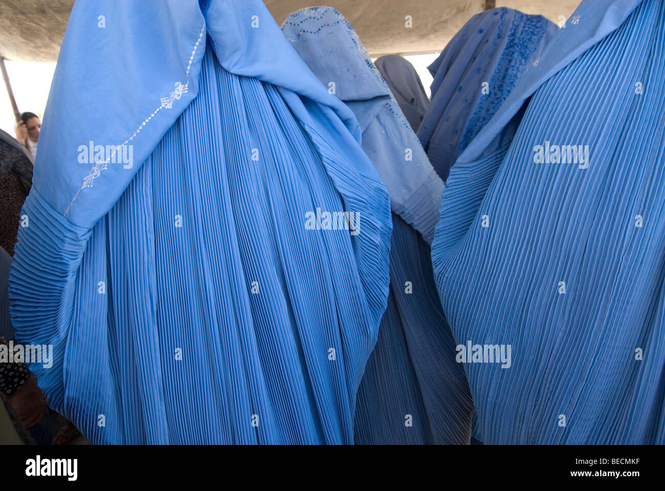 Kabul, Afghanistan Women wearing burkhas wait for food distribution . Stock Photo