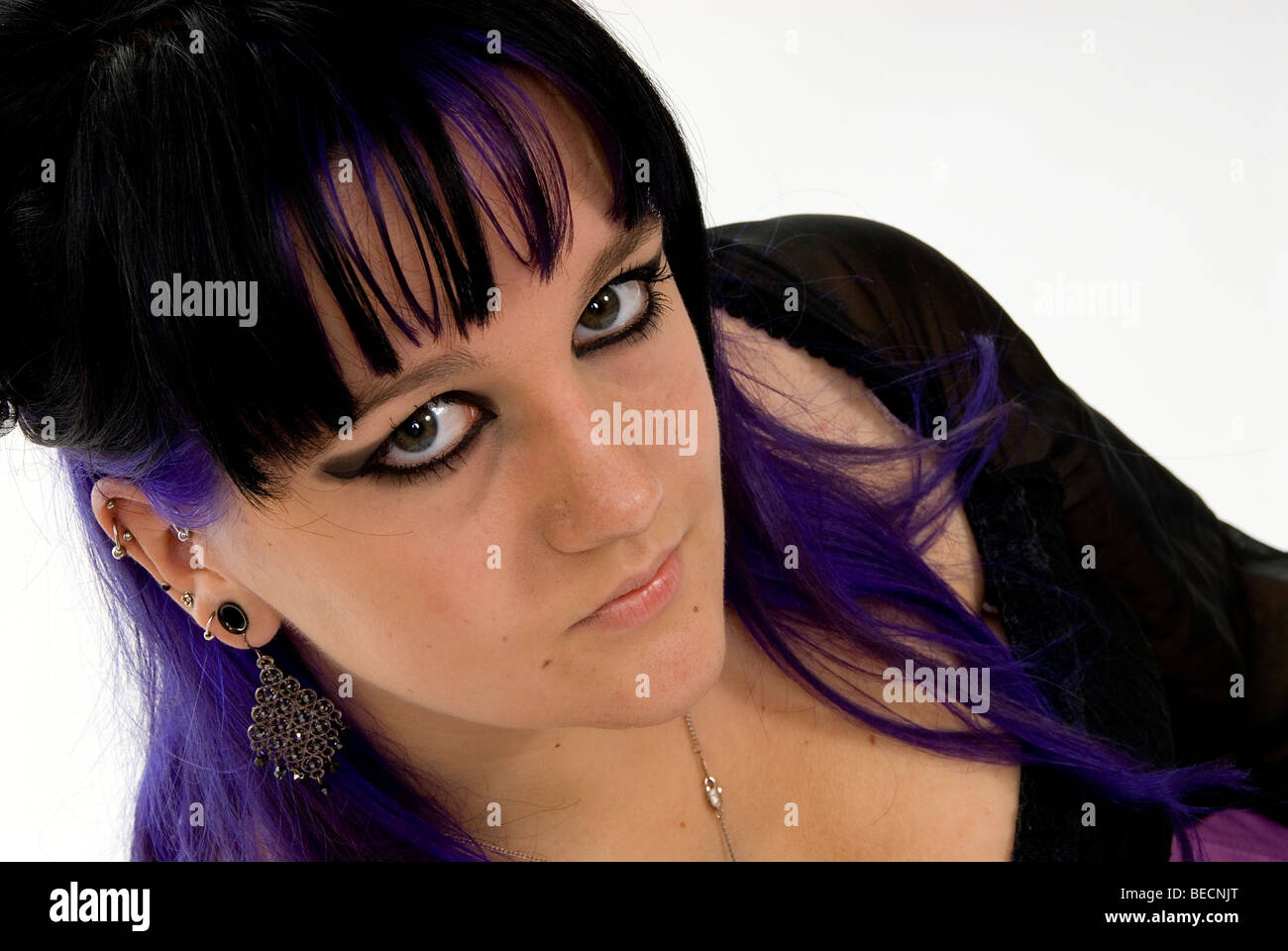 Portrait of cute smiling gothic girl on the roof at sunset time. Pastel goth  with violet (purple) hair in black clothes Stock Photo - Alamy