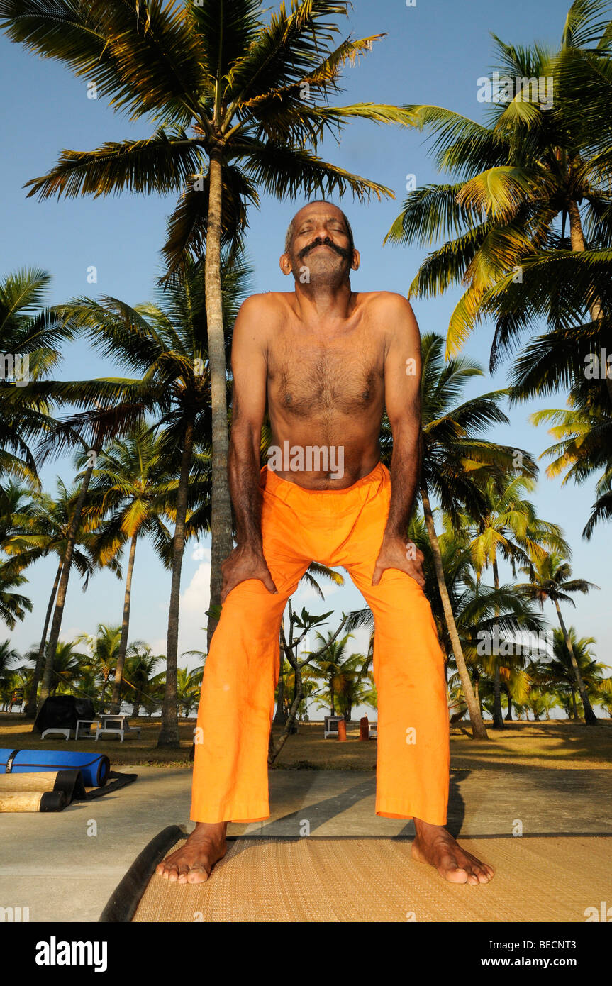 Yoga teacher under palm trees, Kerala, India Stock Photo Alamy