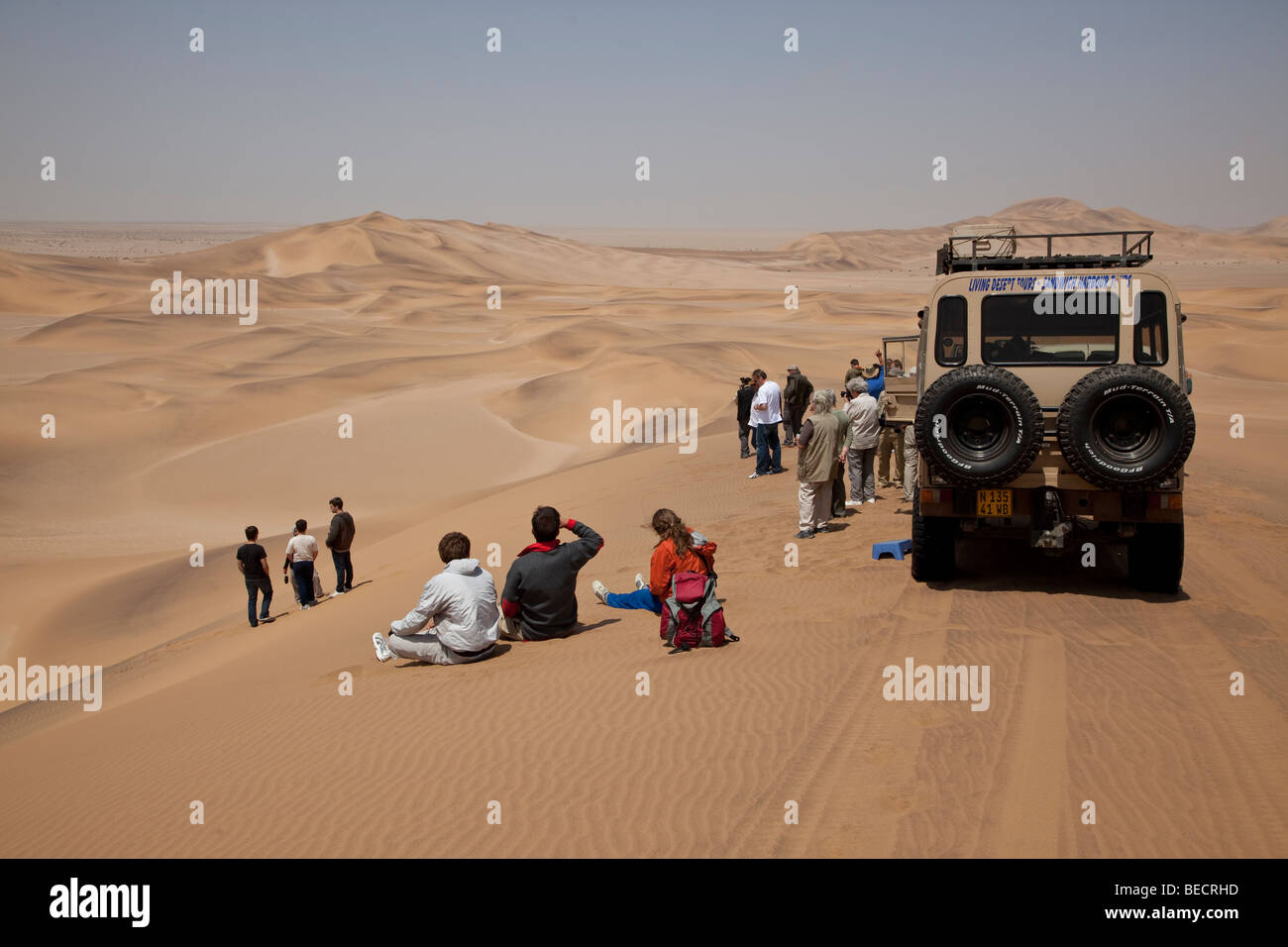 Tourists among sand dunes near Swakopmund, Namib Desert, Namibia, Africa Stock Photo