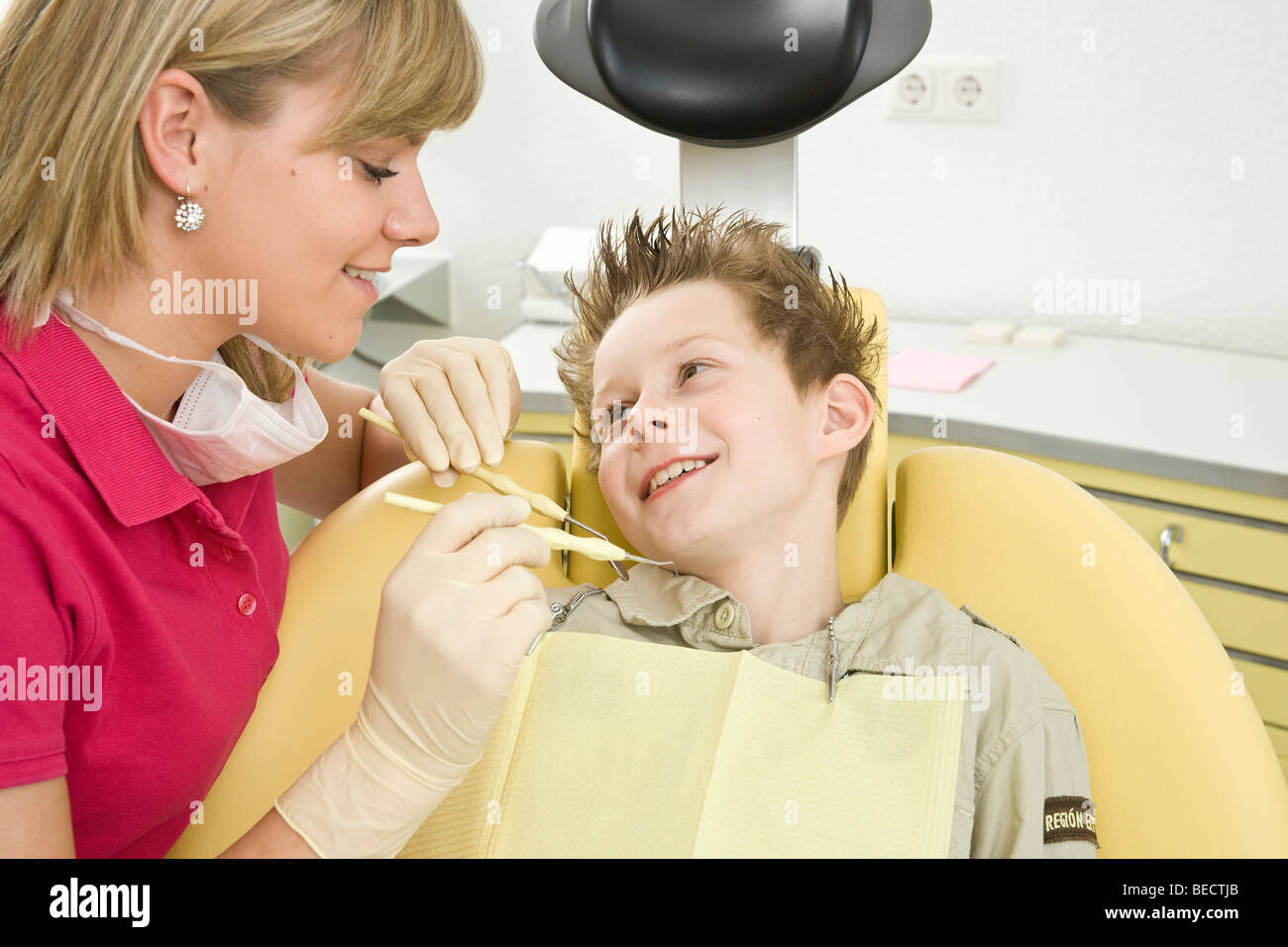 Dental nurse checking a boy's teeth Stock Photo