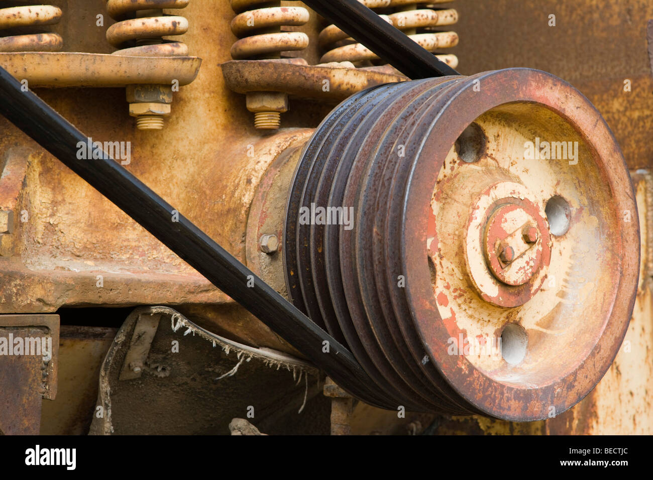 Old rusted driving shaft with belt Stock Photo