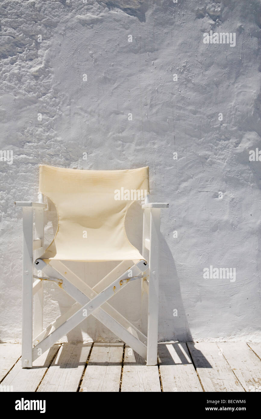 Cream directors chair against a white wall in Greece Stock Photo Alamy