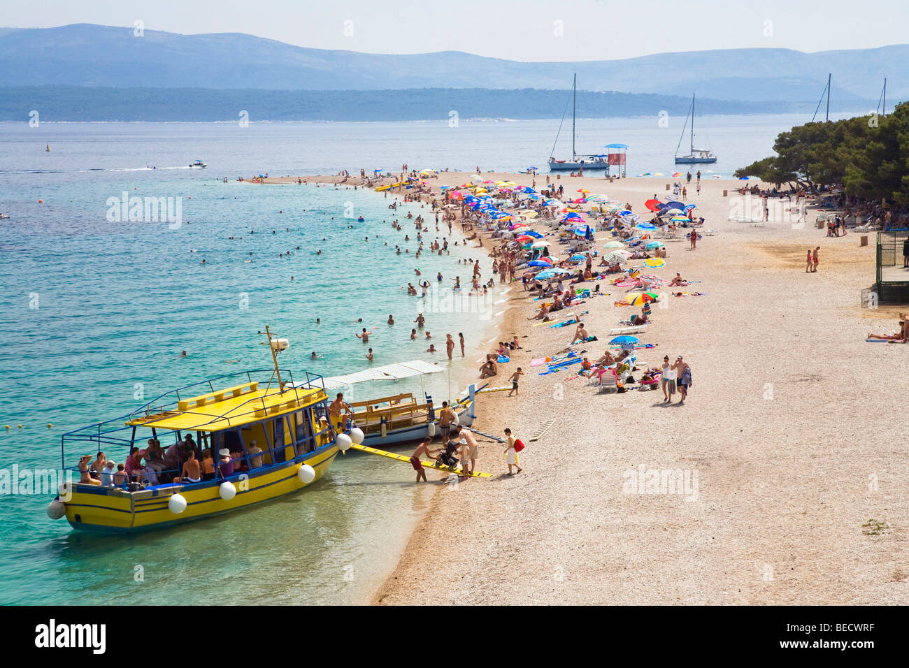 Zlatni Rat Beach with a tourist's boat, Bol, Brac Island, Dalmatia ...