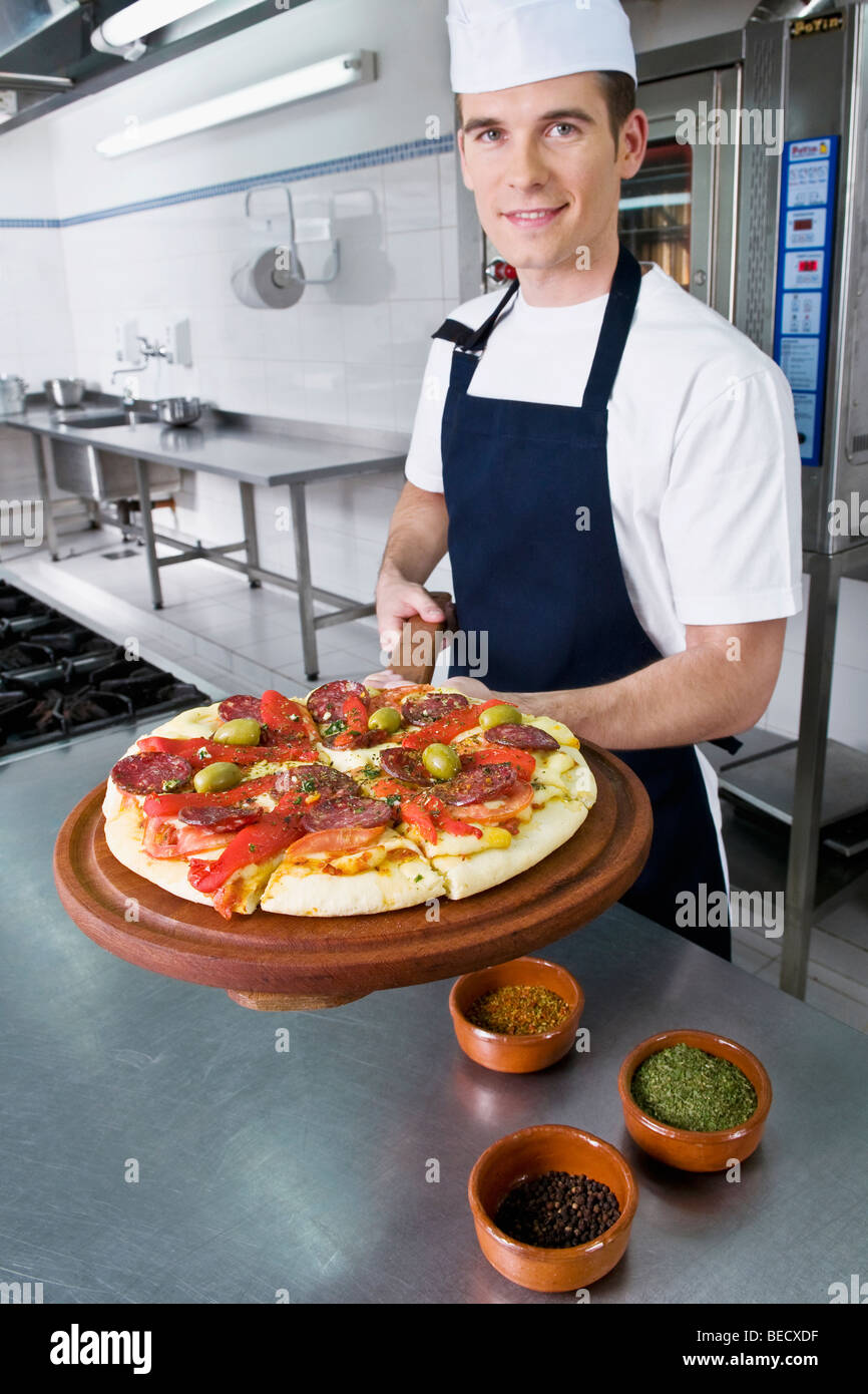 Chef preparing pizza in the kitchen Stock Photo