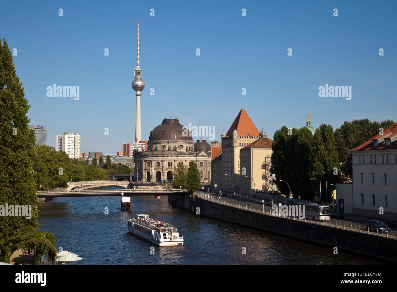 The river Spree with a tourist boat. In the background are the Bode Museum and the television tower. Stock Photo