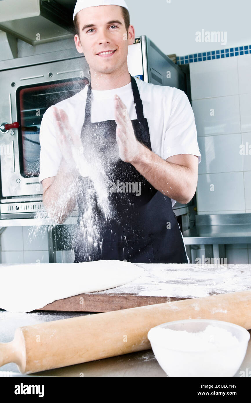 Chef dusting hands with flour Stock Photo Alamy