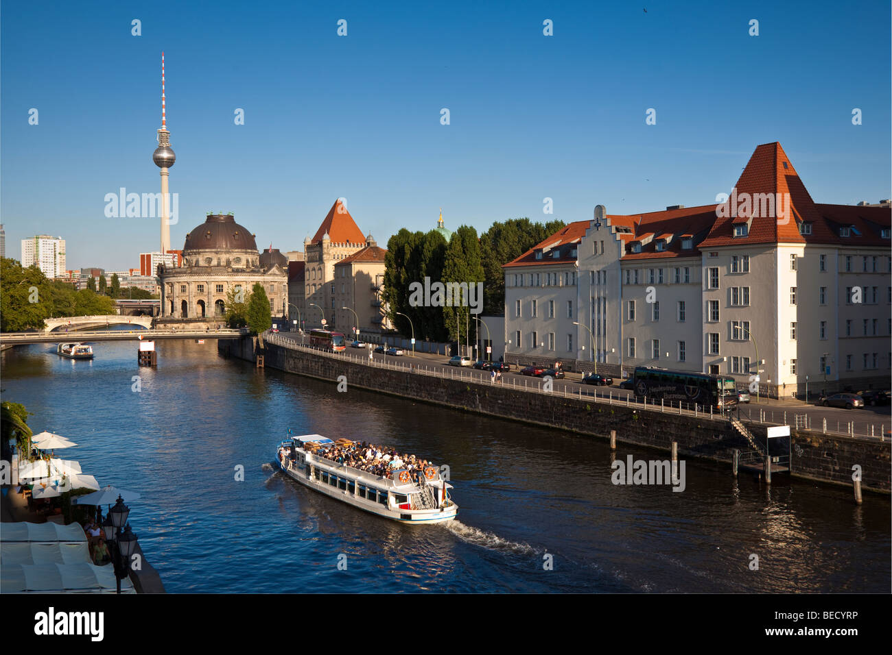 The river Spree with a tourist boat. In the background are the Bode Museum and the television tower. Stock Photo