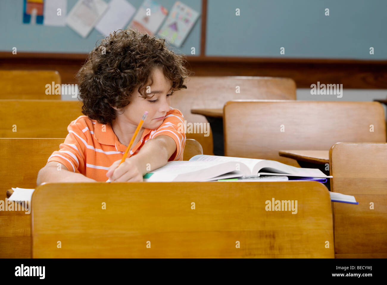 Schoolboy studying in a classroom Stock Photo - Alamy