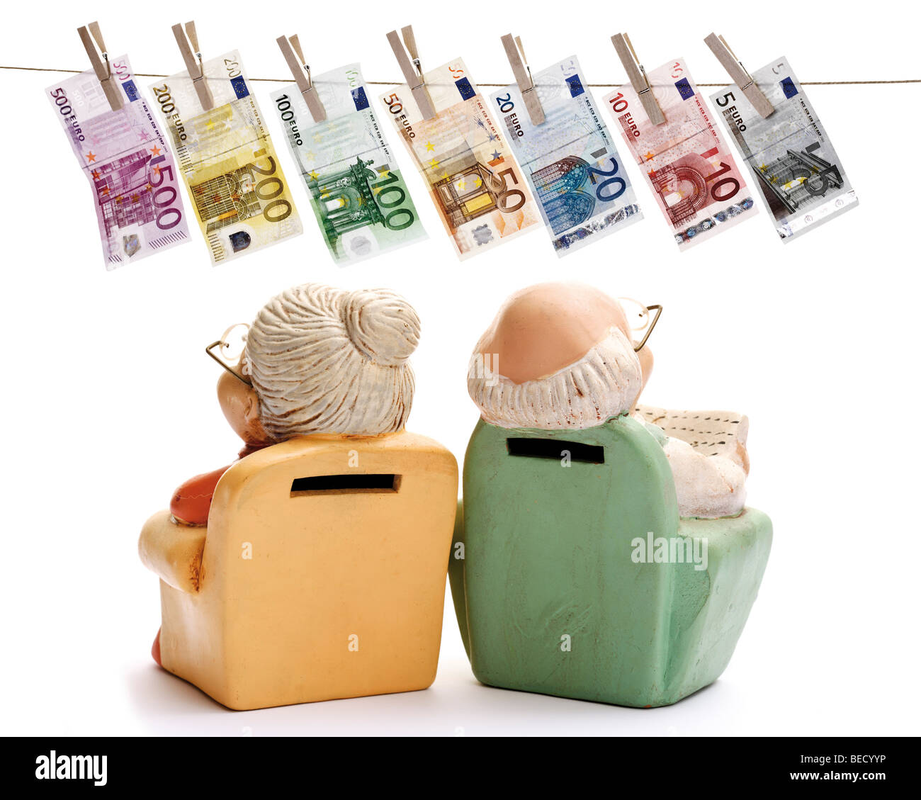Miniature figures of pensioners, grandma and grandpa in an armchair, looking at euro banknotes hanging from a clothesline Stock Photo