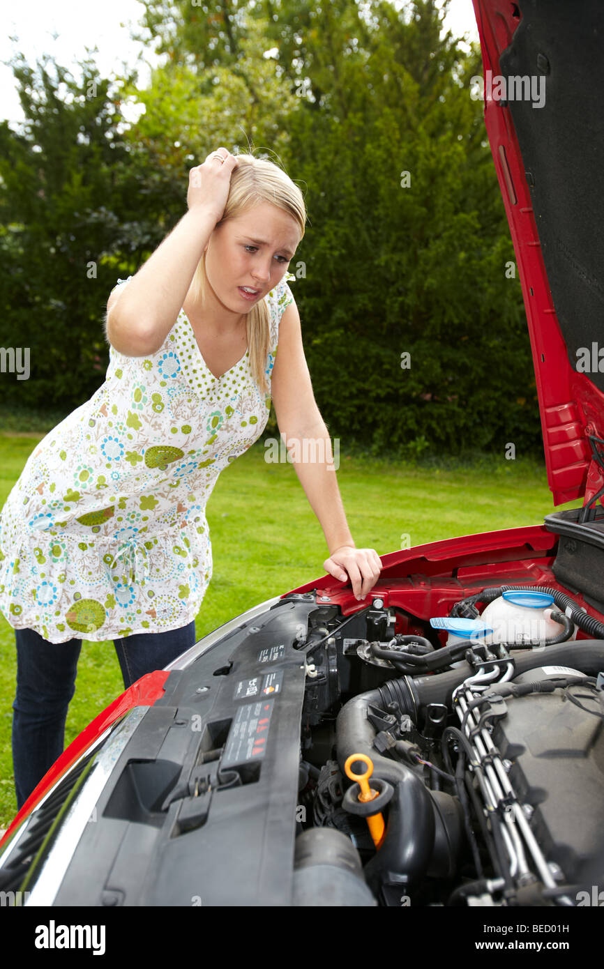 Worried girl with broken down car Stock Photo
