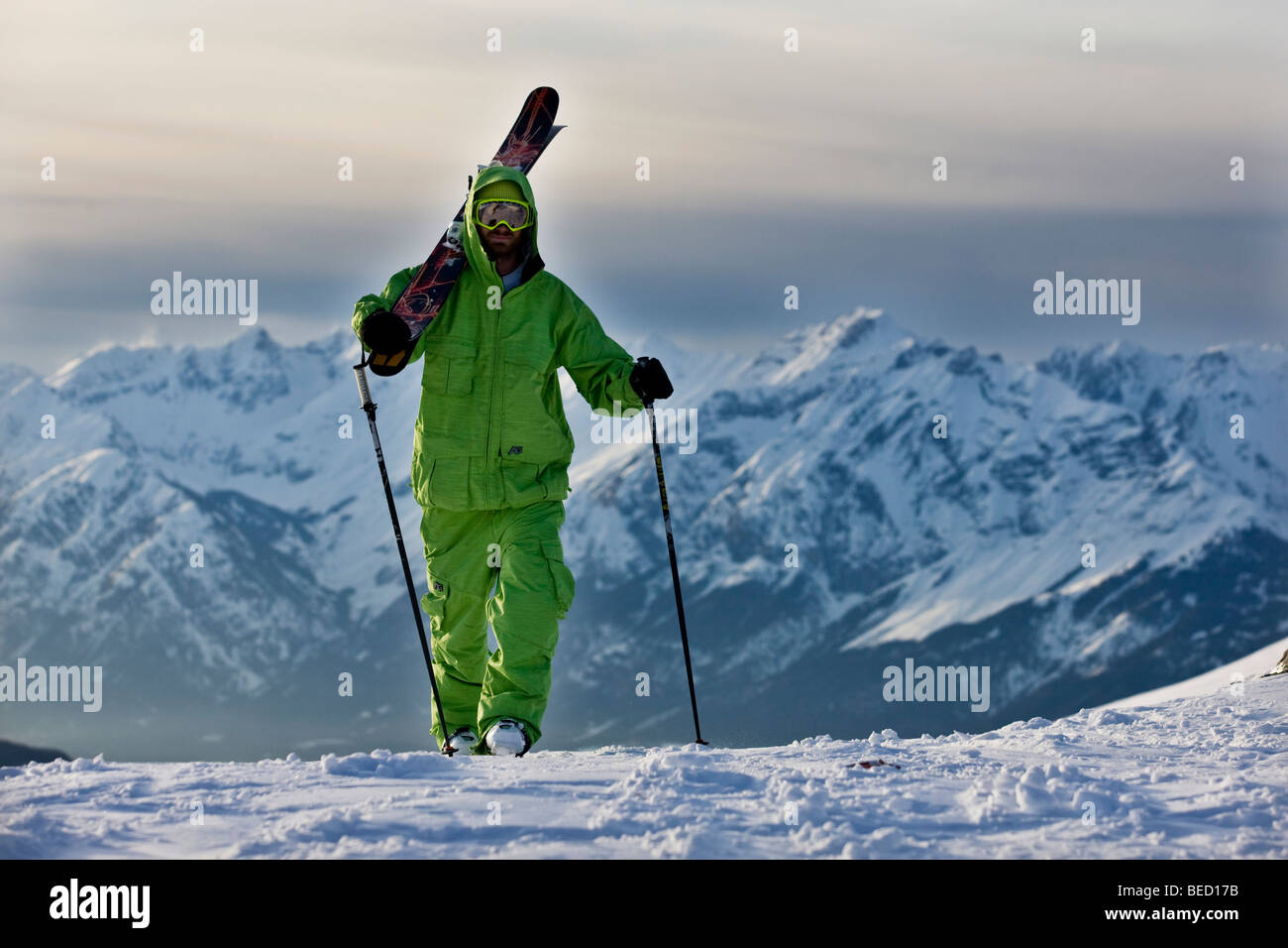 Freestyle skier on the way to a downhill ski run, in front of Karwendel Range, North Tyrol, Austria, Europe Stock Photo