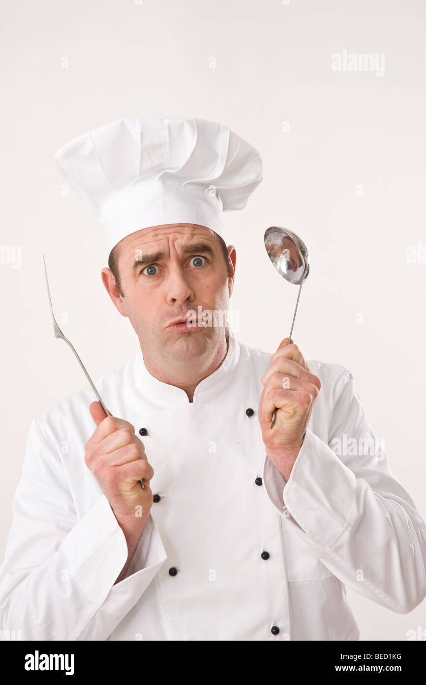 Surprised cook holding a ladle and a scoop Stock Photo Alamy