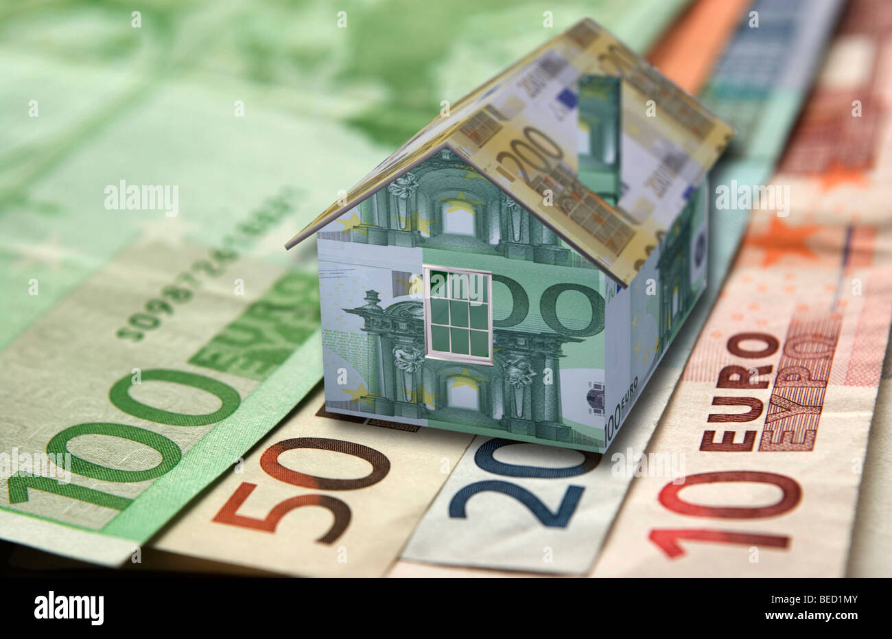 Miniature house and banknotes Stock Photo