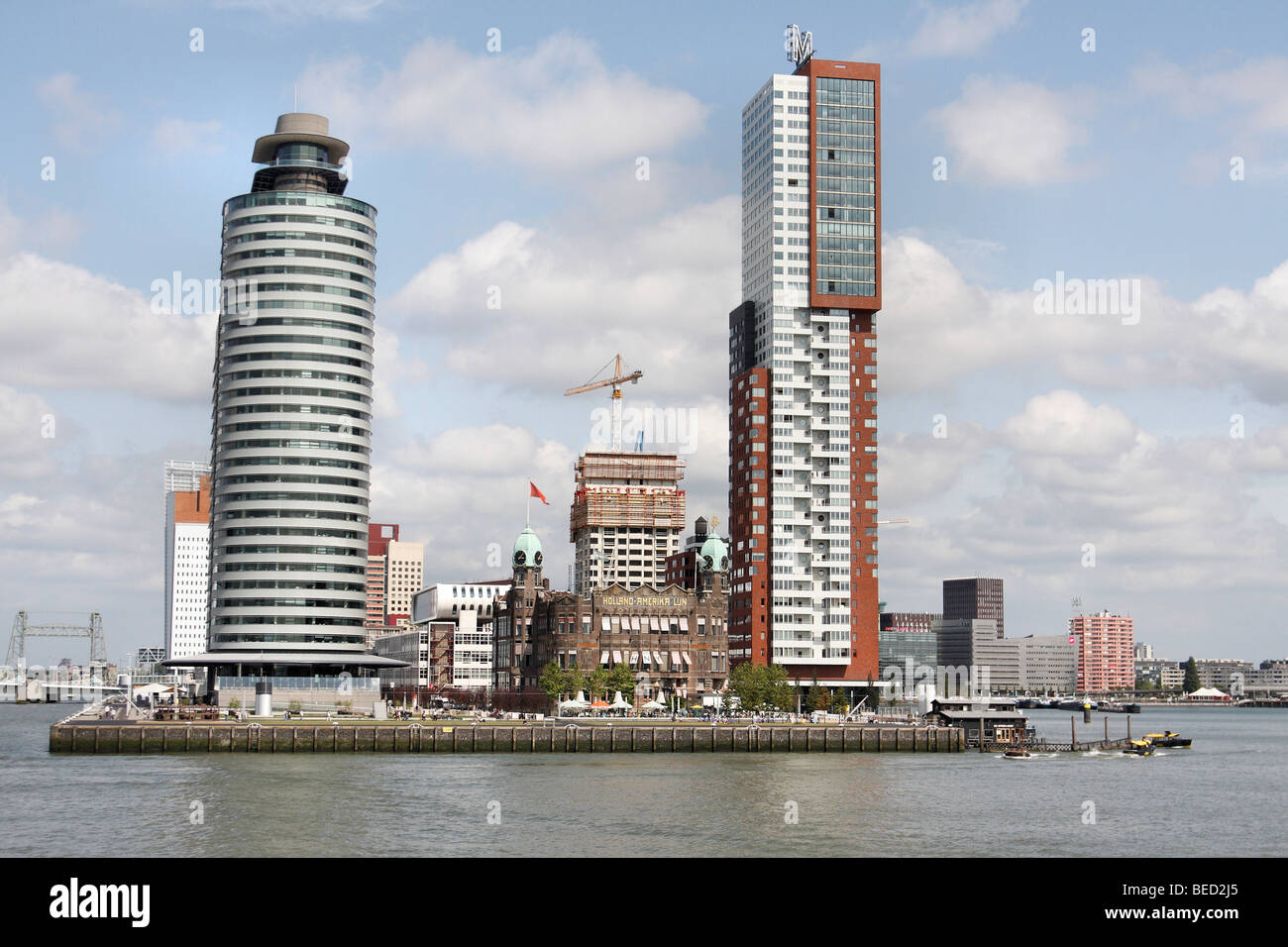 The old Holland America Lines offices flanked by two new hotels in the