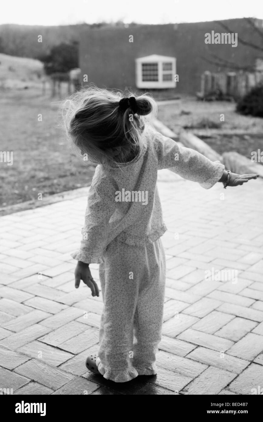 Rear view of a baby girl with her arms outstretched, Santa Fe, New Mexico, USA Stock Photo
