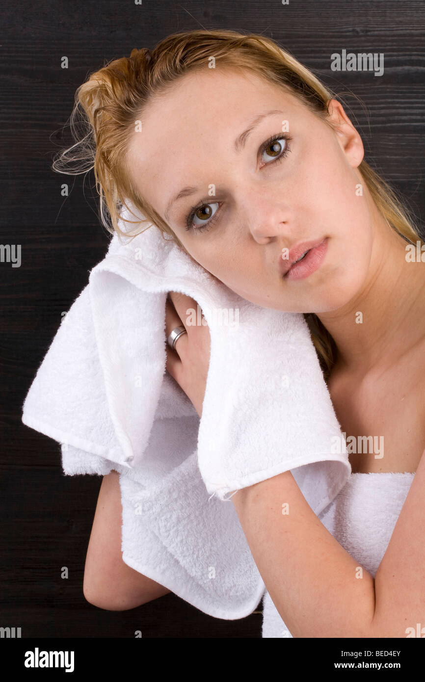 Young woman drying her wet hair with a towel Stock Photo