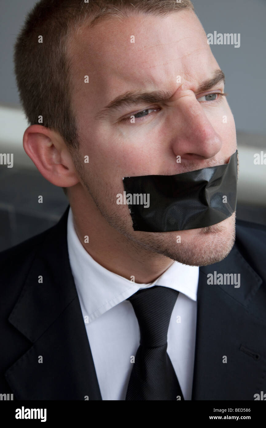 Business man silenced by tape on his mouth Stock Photo