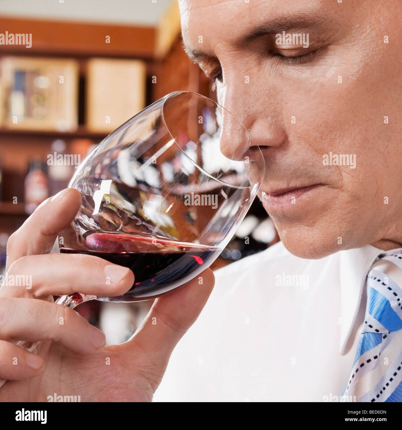 Businessman smelling red wine in a bar Stock Photo - Alamy
