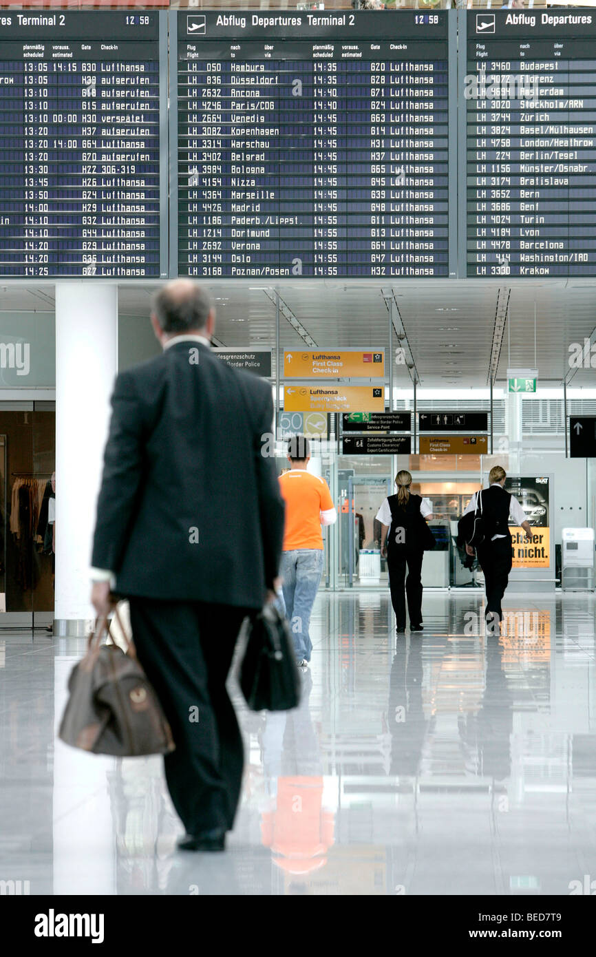 Passengers in front of the information board listing the departure times, Terminal 2 of Munich Airport, Franz-Josef-Strauss Air Stock Photo