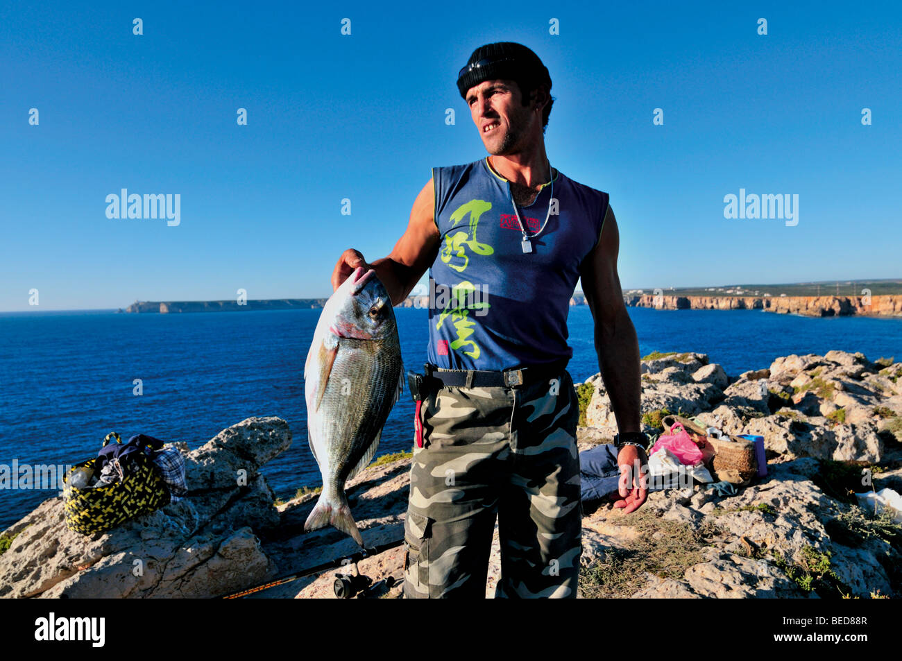 Portugal, Algarve: Young fisherman with fresh caught fish from the westcoast Stock Photo