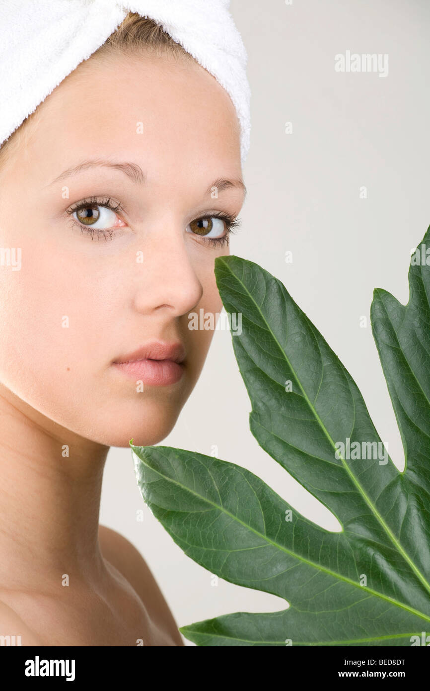 Young woman, towel wrapped around her head, herbal skin care Stock Photo