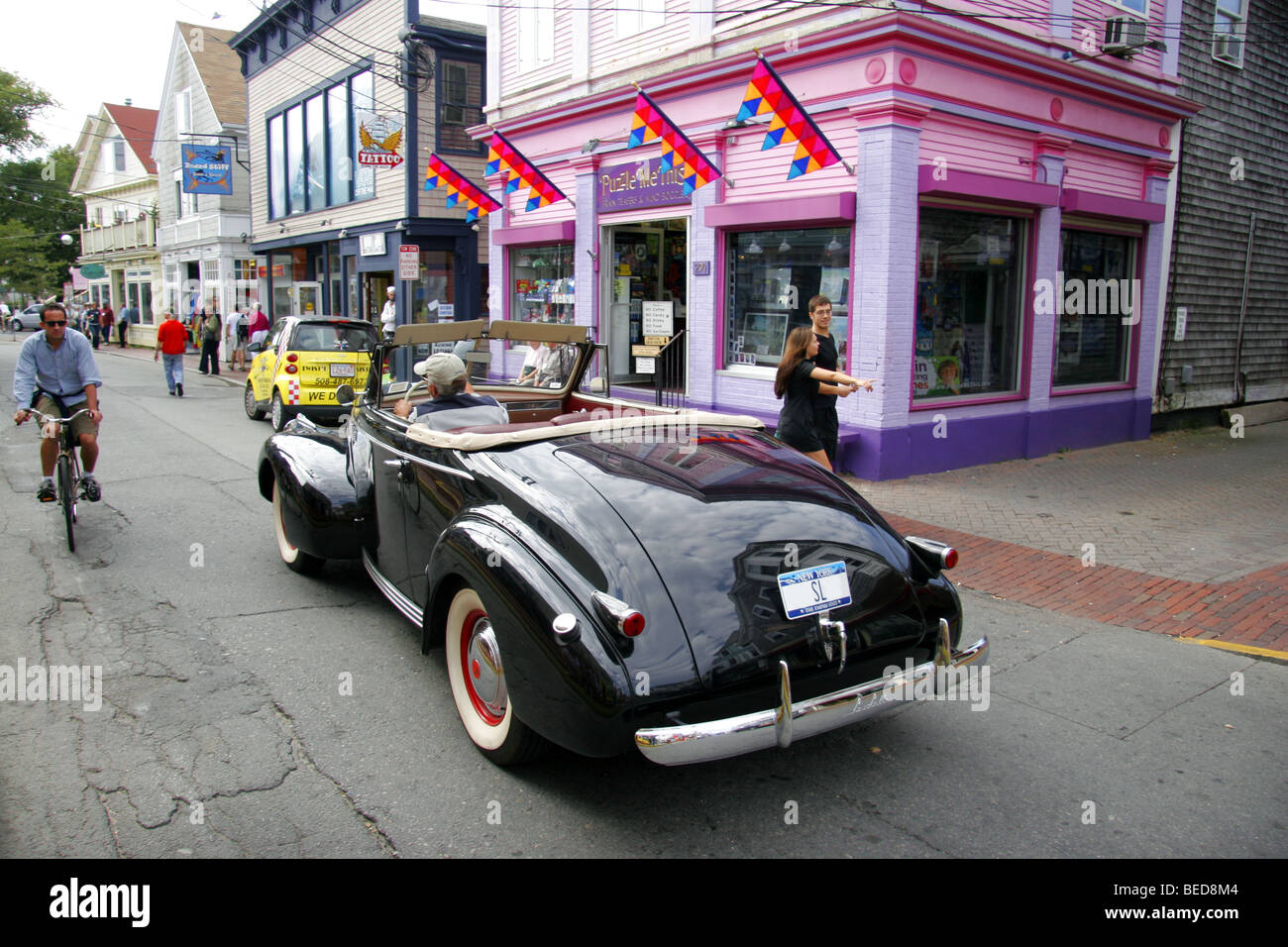 Classic old car driving along Commercial Avenue, Provincetown, Massachusetts, USA Stock Photo