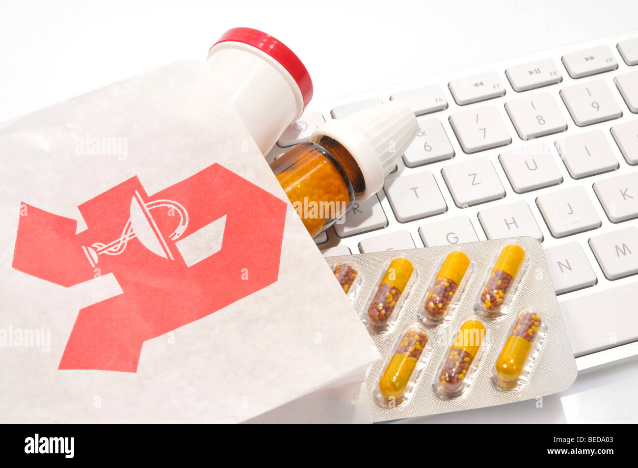 Bag from a German chemist, medicine and a computer keyboard, symbolic image for ordering medicine over the internet Stock Photo