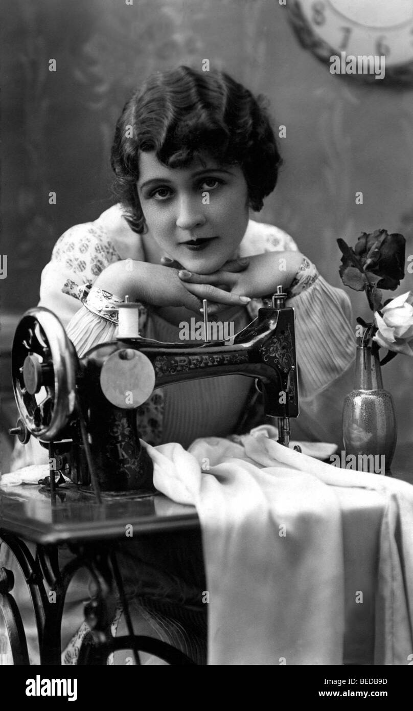 Historic photograph, woman with a sewing machine, around 1910 Stock Photo