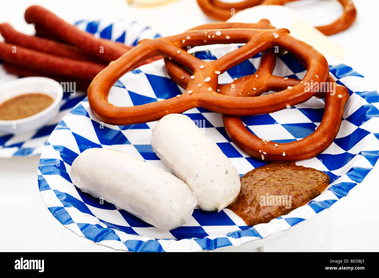 Veal sausages with sweet mustard, salted pretzels, ham Mettwurst sausages and beer Stock Photo