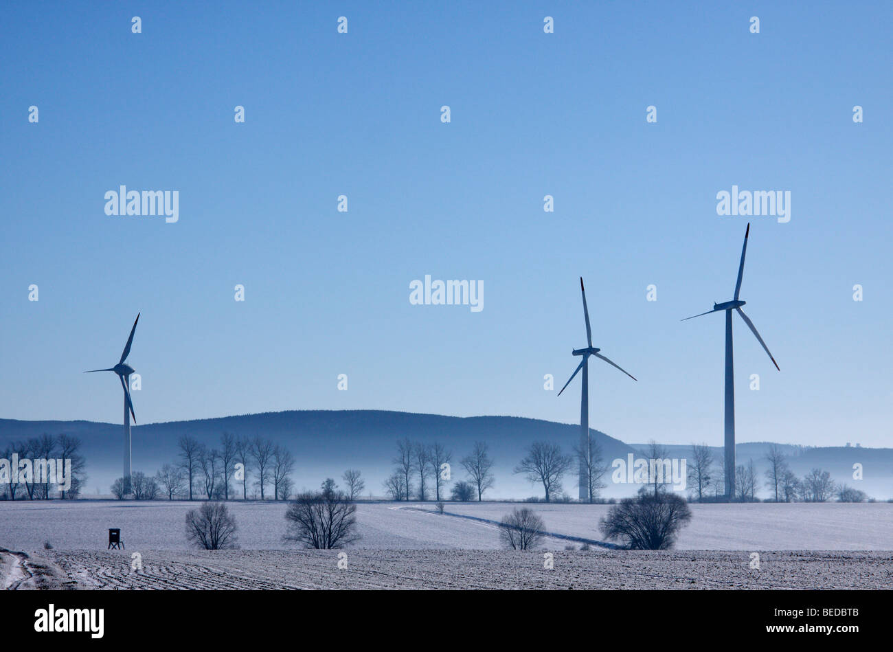 Wintery landscape, wind power plant and fog Stock Photo