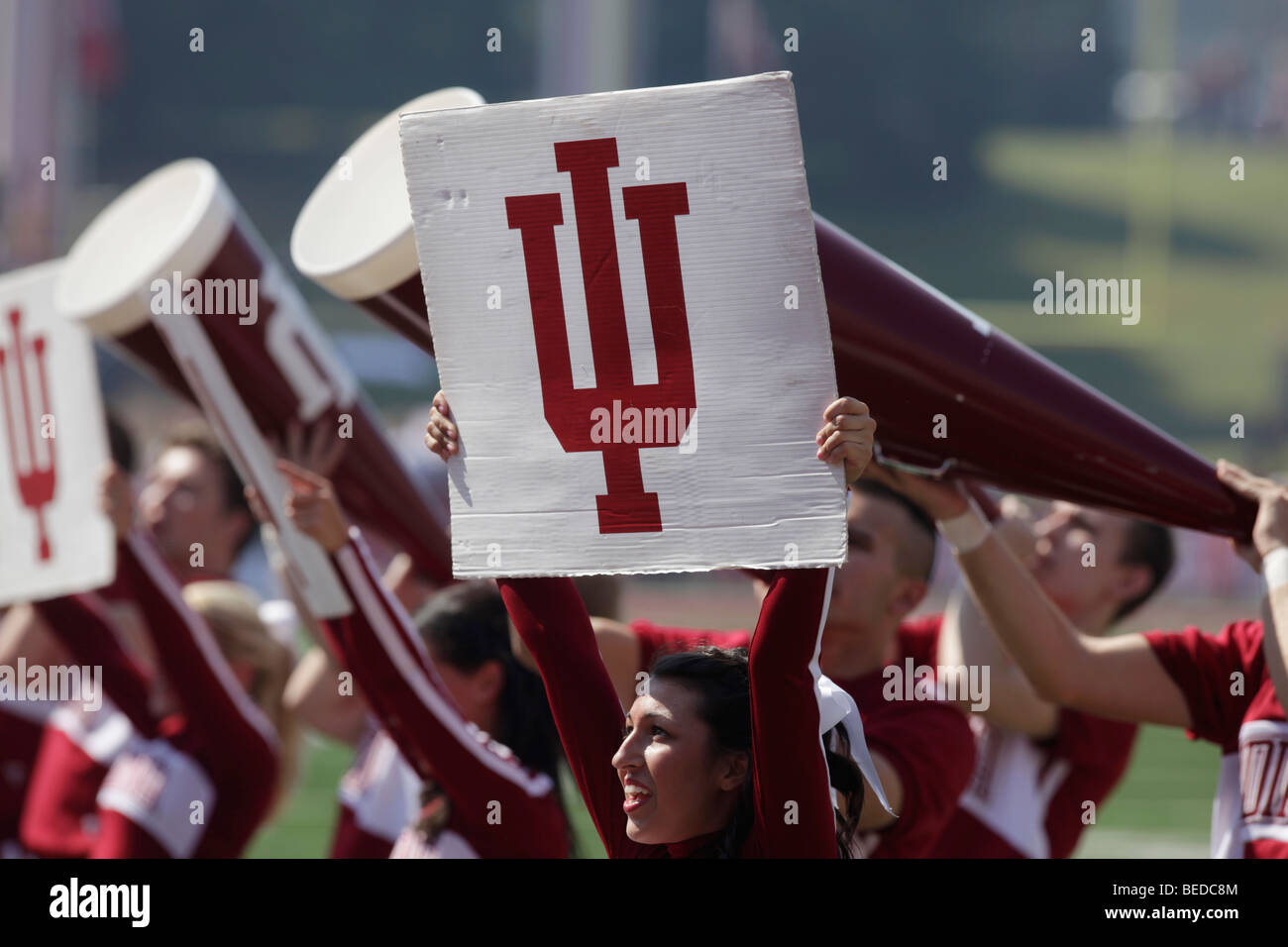 IU cheerleaders cheering during an Indiana University football game. Stock Photo