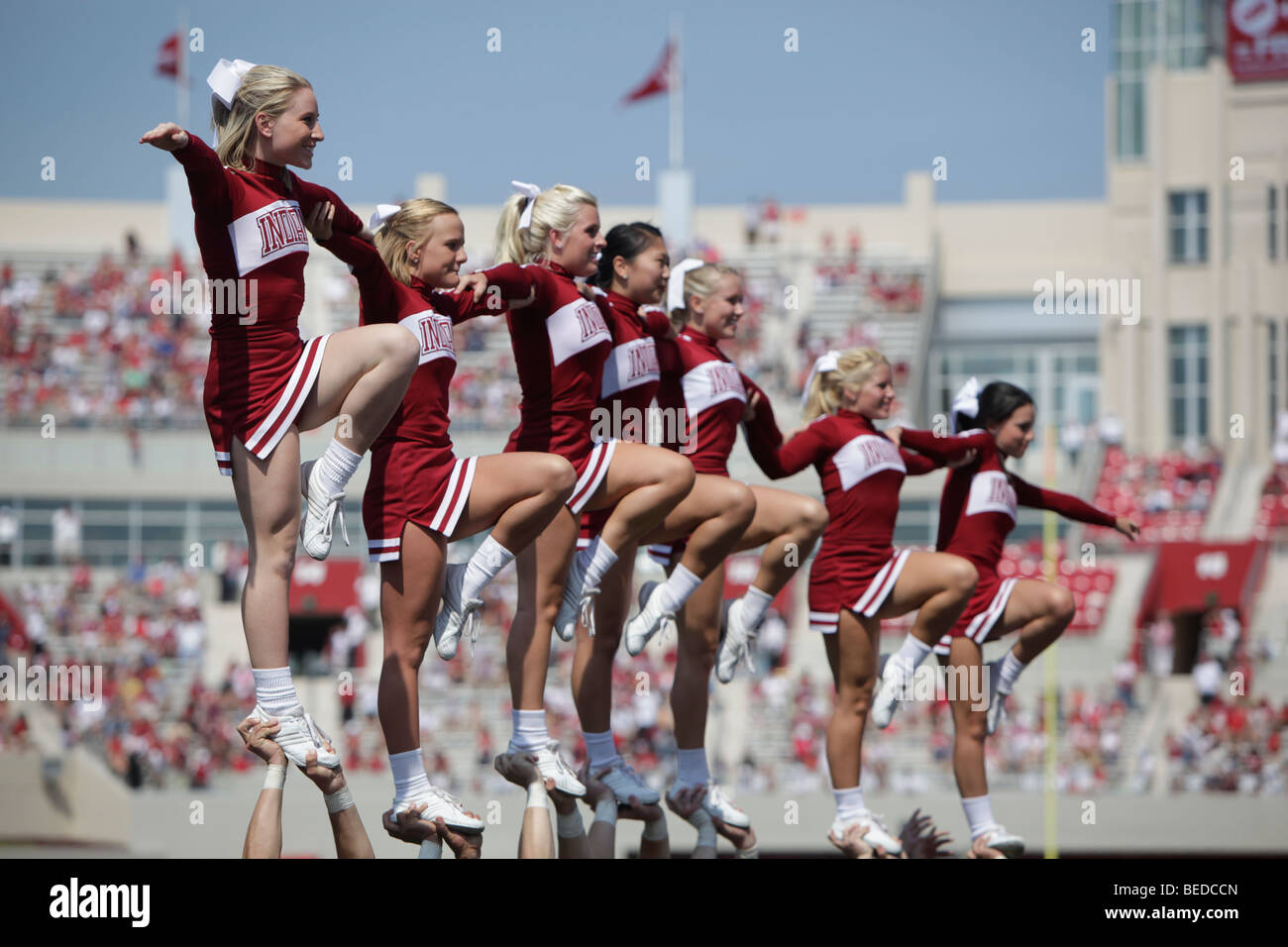 IU cheerleaders during an Indiana University football game with the new stadium construction in the background. Stock Photo