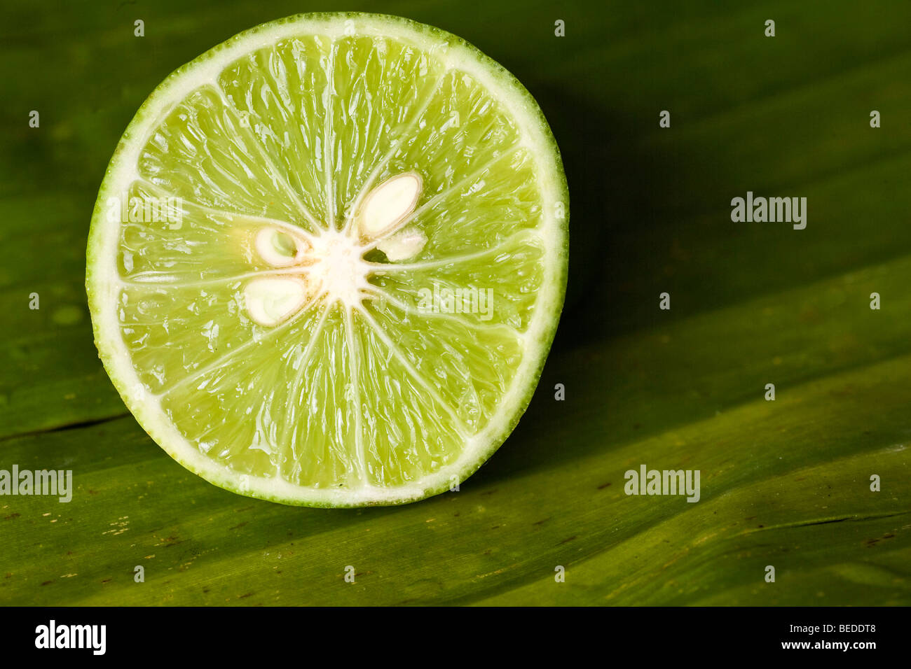 Cut lime on a banana leaf Stock Photo