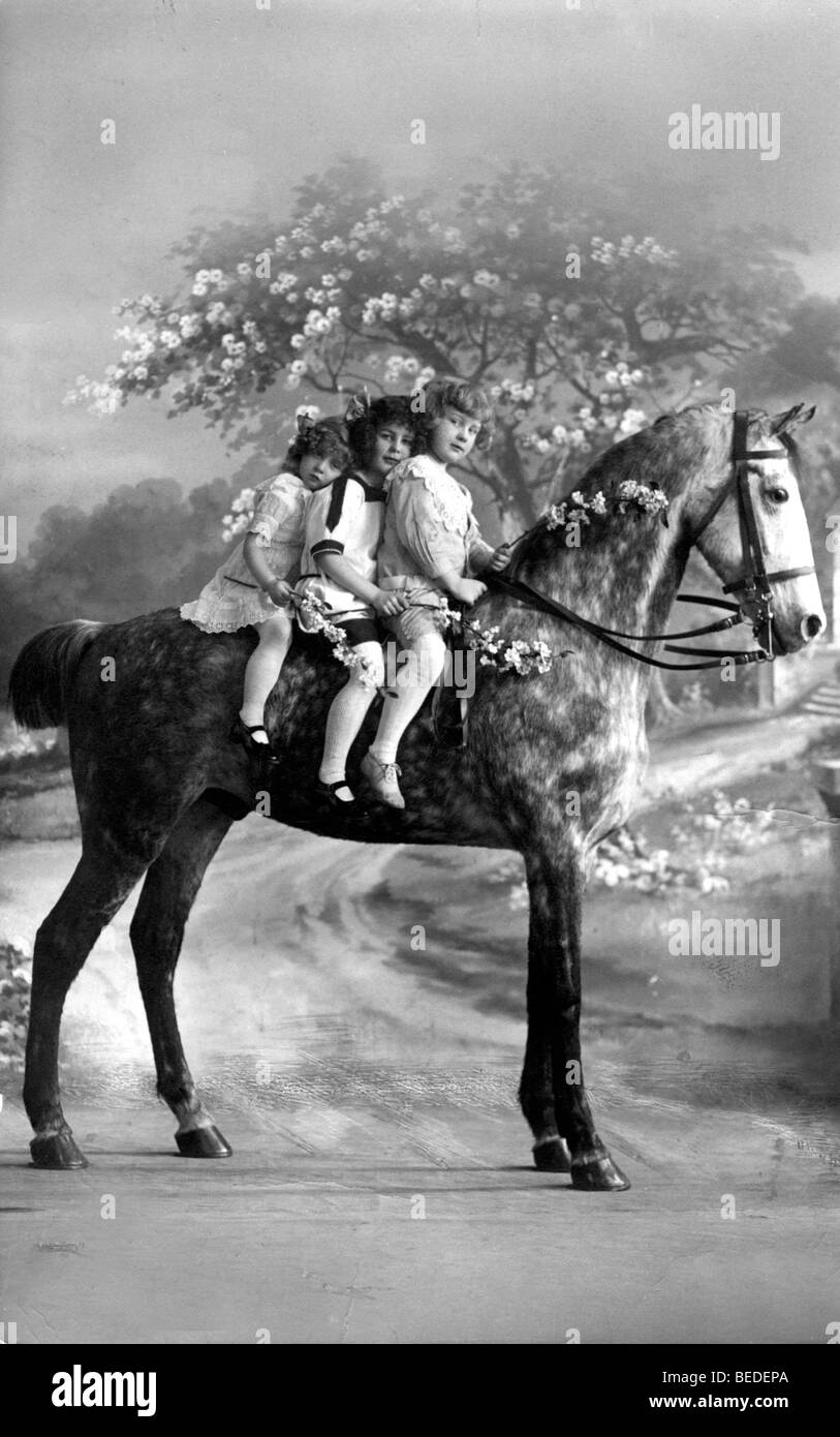 Historic photograph, three children riding a horse, around 1922 Stock Photo