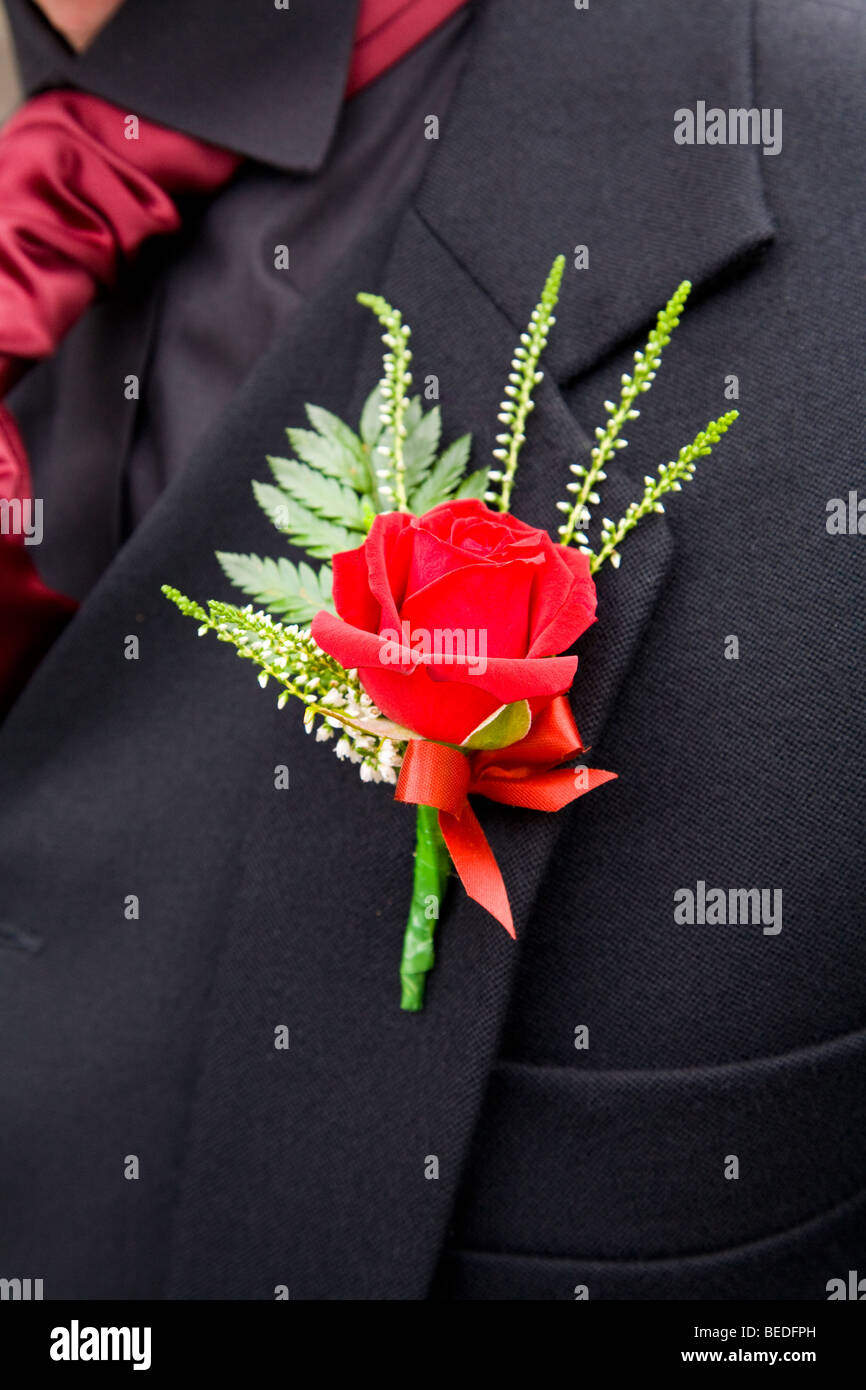 Red rose and white heather buttonhole on Groom at a Scottish Wedding Stock Photo