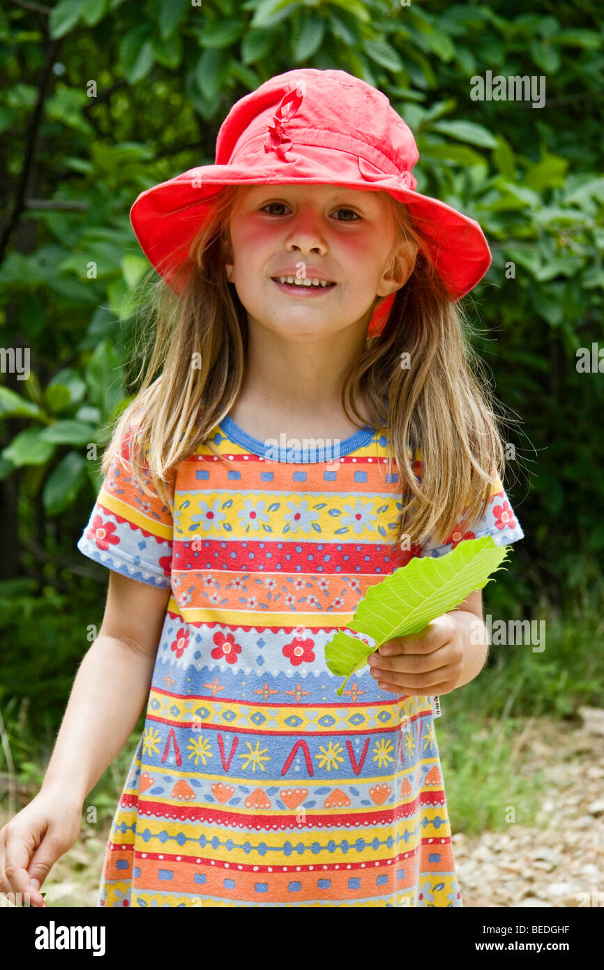 Young girl wearing a red sun hat Stock Photo Alamy
