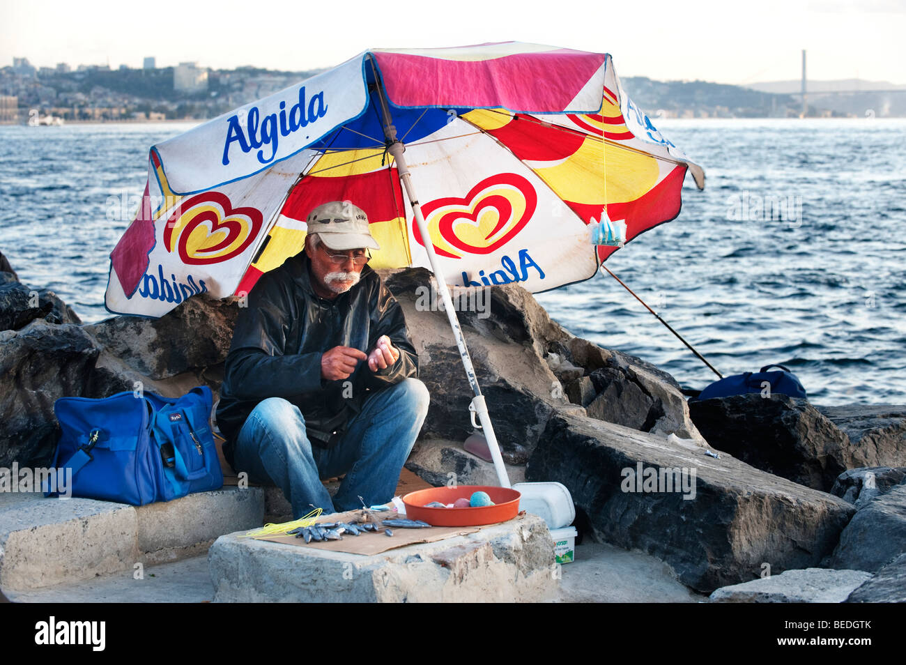 Turkish fisherman in Istanul preparing lines and weights beside the Bosphorus. Stock Photo