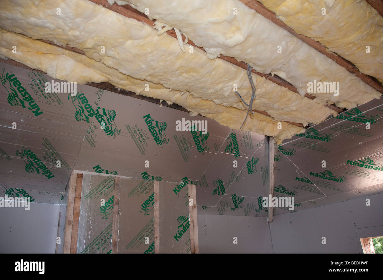Fibreglass insulation in roof cavity before ceiling boards fitted. Stock Photo