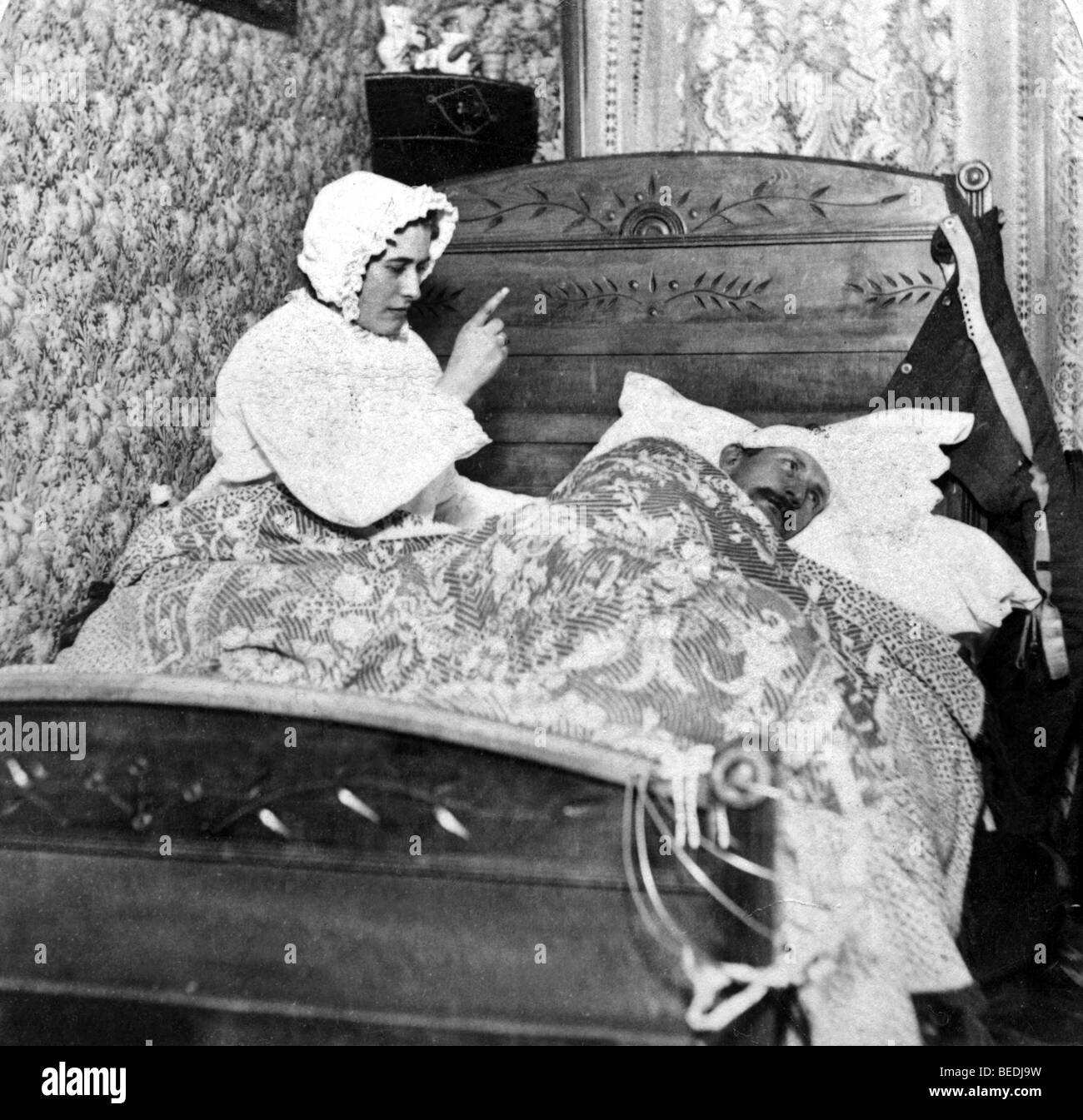 Historic photograph, woman scolding her husband in bed, around 1900 Stock Photo