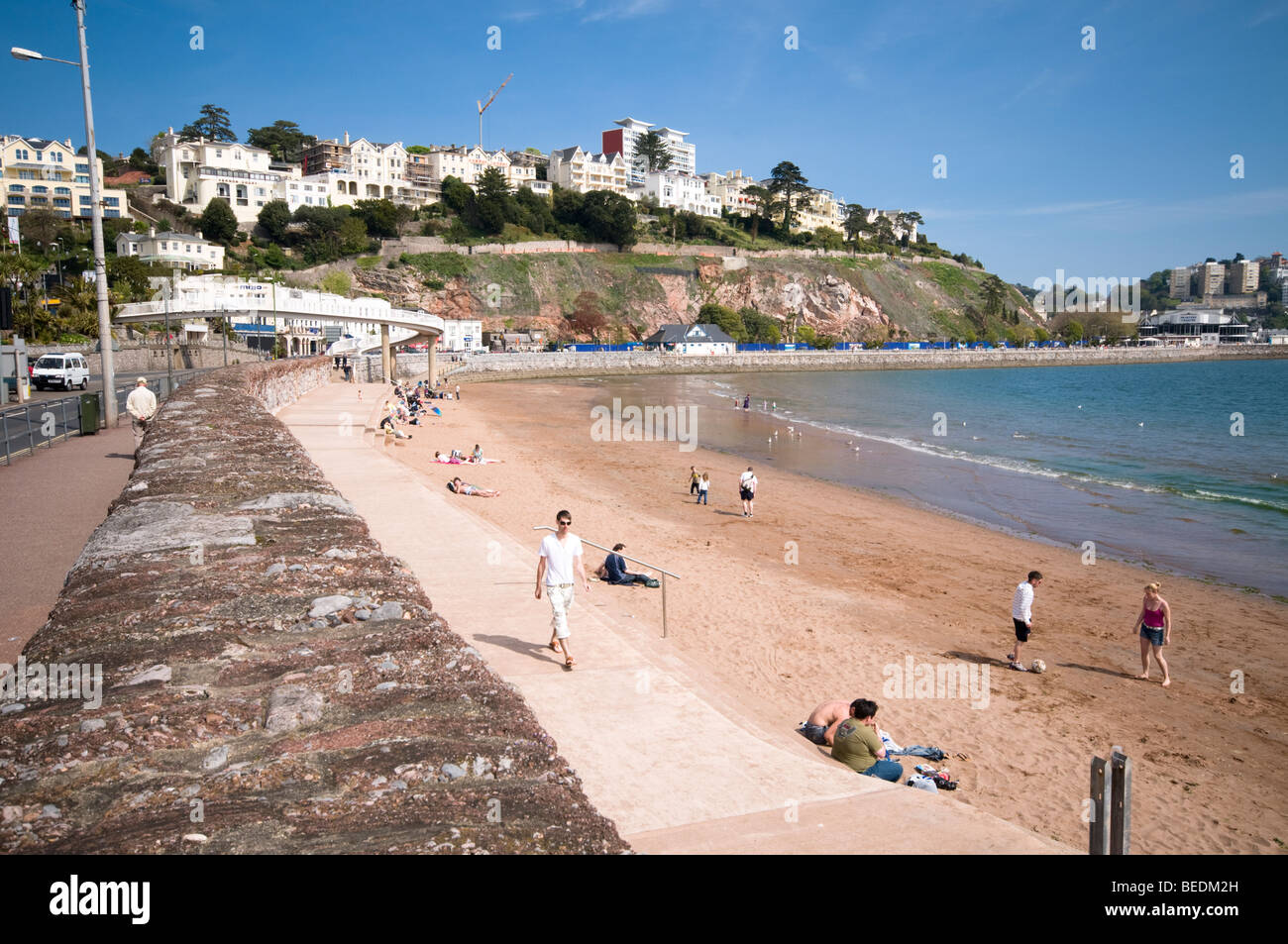 People enjoying sunshine on sandy beach, Torquay, Devon, UK Stock Photo