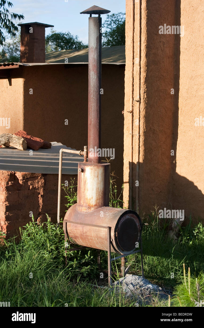 Wood burning hot water boiler, Tanzania Stock Photo