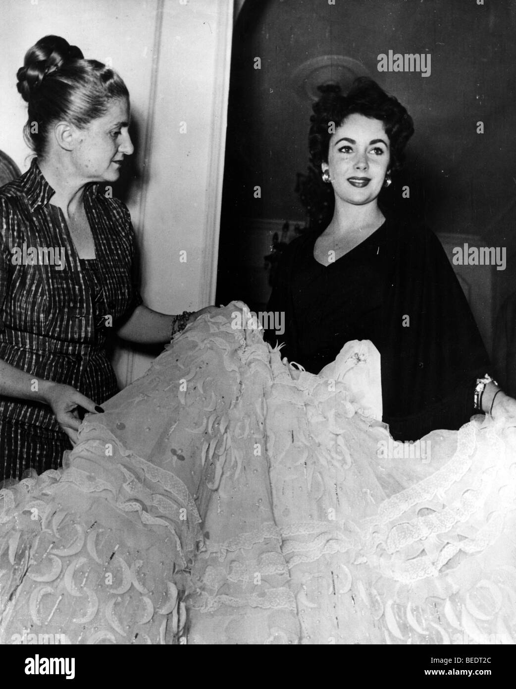 Actress Elizabeth Taylor being fitted in a gown Stock Photo