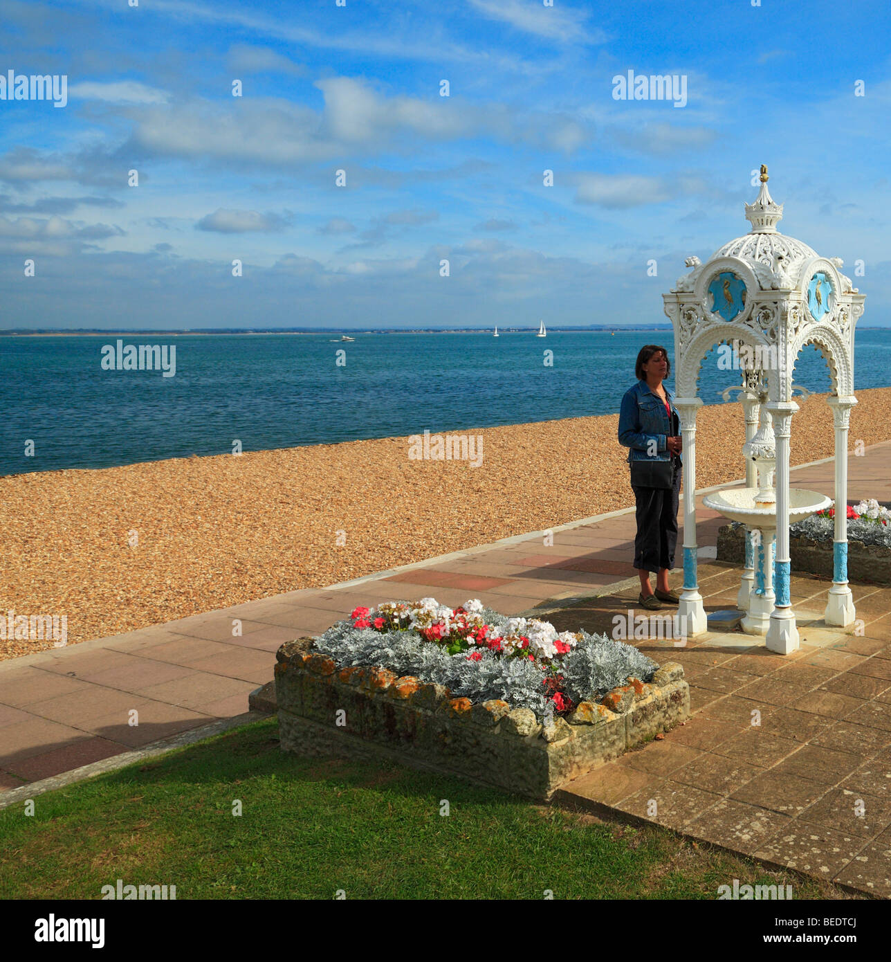 Woman looking at an old Victorian drinking Fountain. Cowes, Isle of Wight, England, UK. Stock Photo
