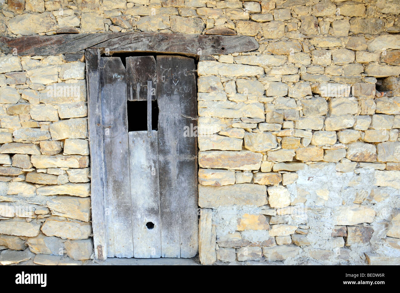 Old wooden door in a stone wall Stock Photo - Alamy