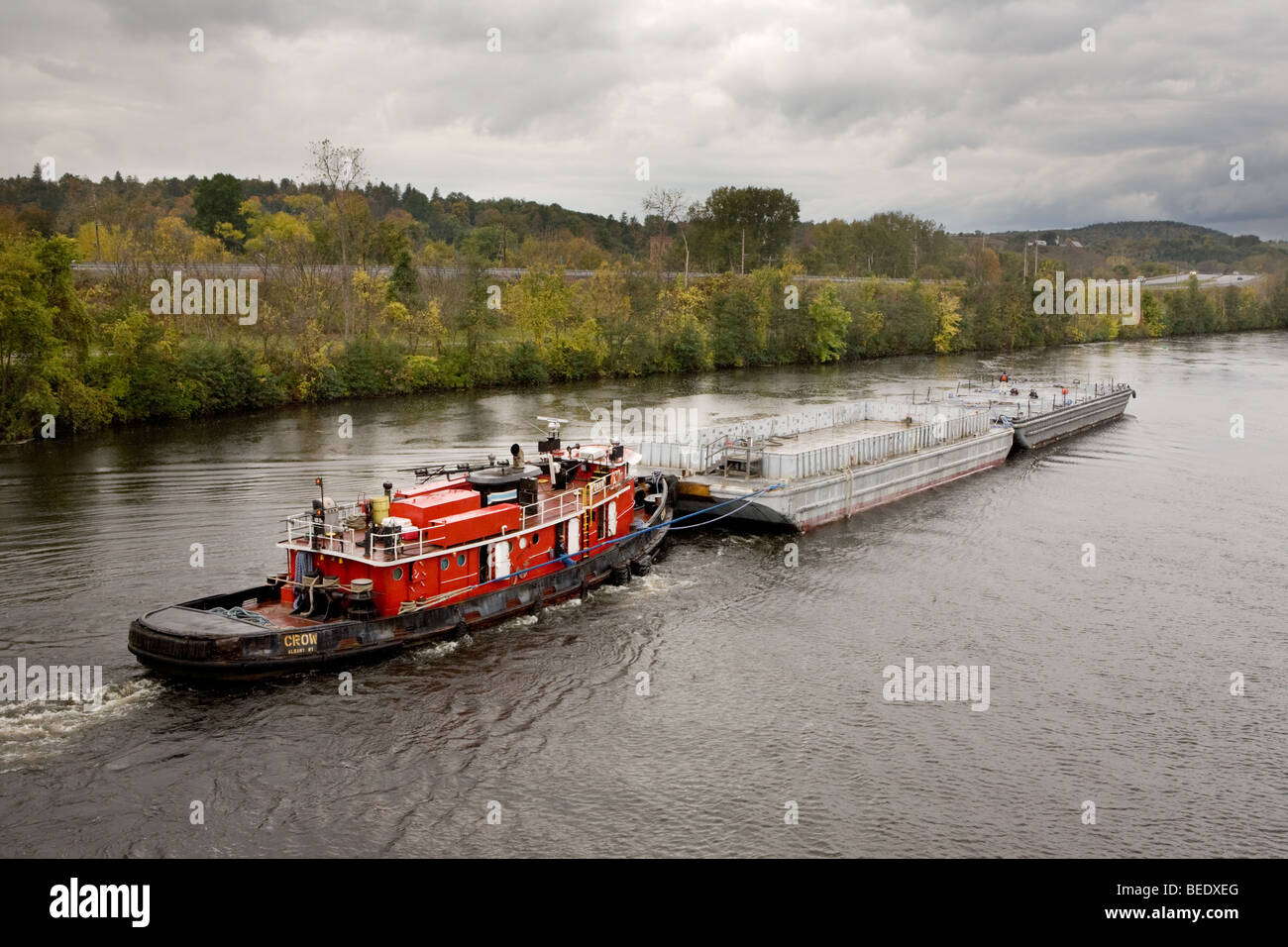 The tug boat Crow pushing two work barges westbound on the Erie Canal Stock Photo
